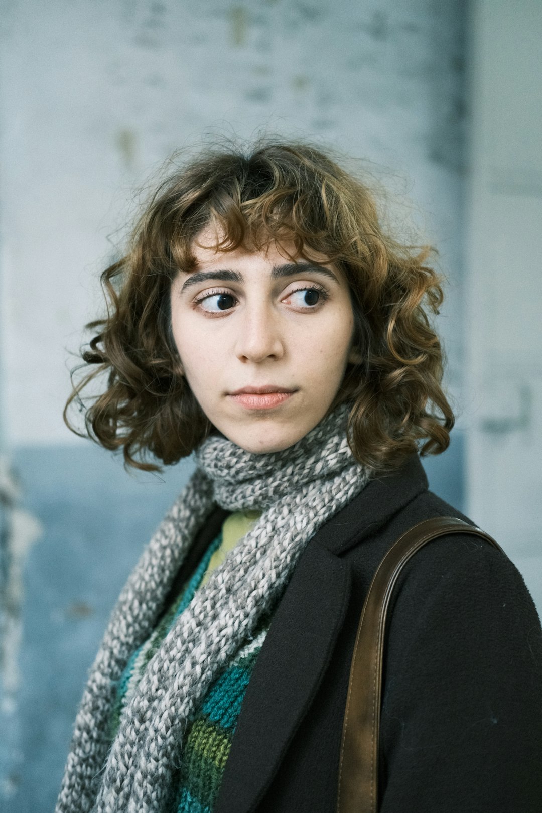 Woman over 40 with a curly shoulder length haircut