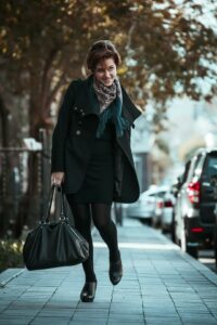 Stylish woman wearing an elegant fall coat and handbag
