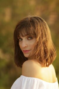 Woman with soft wispy curtain bangs and medium length hair